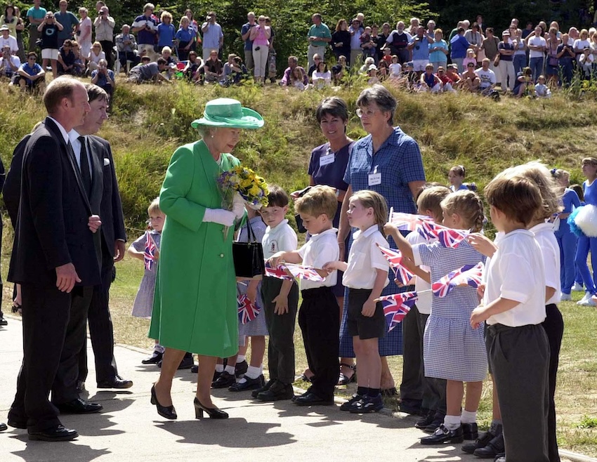 The Queen is greeted by school children outside St Anne's School on the island of Alderney, on the first day of her two day visit to the Channel Islands