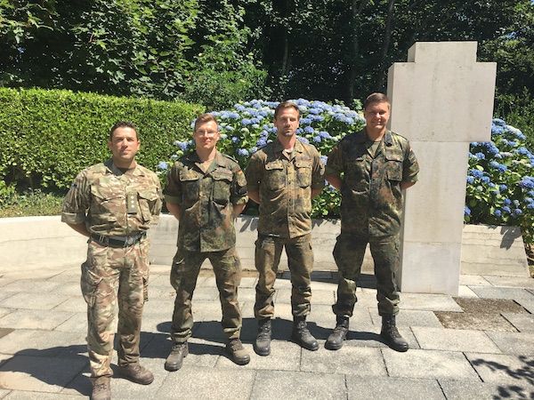 Allied Soldiers work at cleaning up military headstones